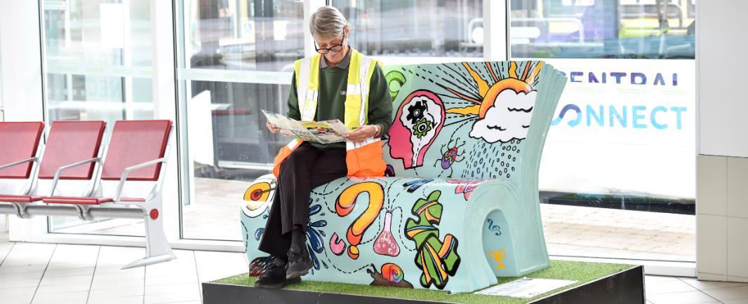Lady reading on a book bench